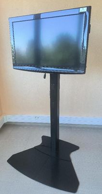 a flat screen tv on a stand in the corner of a room