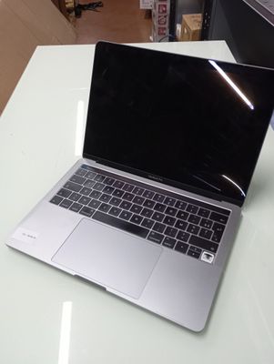 a laptop computer sitting on top of a white table