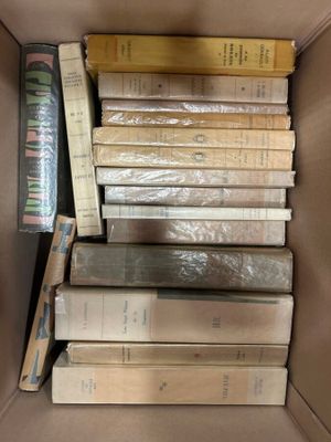 a box full of books sitting on top of each other
