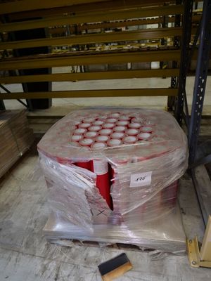 a pallet with a bunch of cans on it in a warehouse