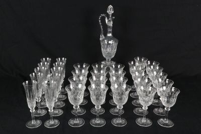 a lot of wine glasses and a pitcher on the table