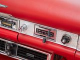 a close up of a red car dashboard with a clock on it