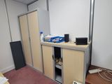 an image of a room with a desk and cabinets