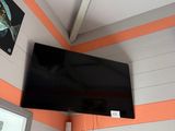 a flat screen tv hanging on the wall in a room