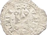 a close up of a coin on a white surface