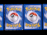 three packs of pokemon toys are on display on a black background