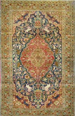 an antique persian rug with a floral design on a blue ground