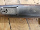 a close up of a gun on a wooden table