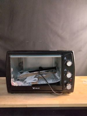 a toaster oven sitting on top of a wooden table