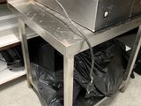 a machine that is sitting in a kitchen with bags on the floor