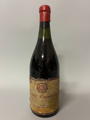an old bottle of wine sitting on top of a white table