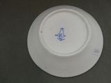 a white plate with a blue bird on it
