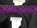 a close up of a purple and black dress with a label on it