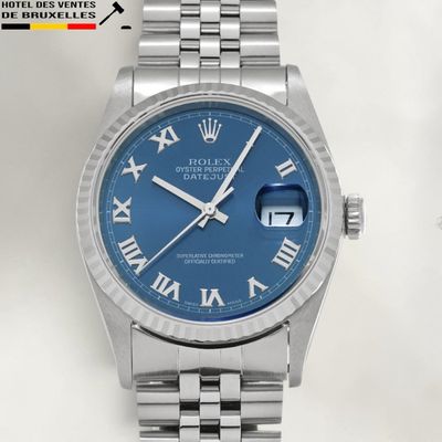a close up of a wrist watch with roman numerals on it
