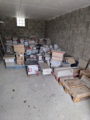 many boxes of books stacked on the floor in a room