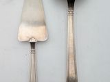 two spoons and a ladle on a table