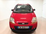 a red car that is parked in a room
