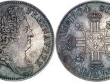 a close up of a silver coin with a crown on it