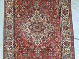 a red rug with a medallion design on the middle of it