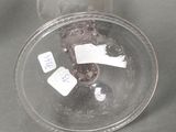 a clear glass with a brown bear inside of it