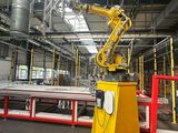 a robot that is sitting on a yellow stand