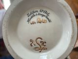 a white bowl with a gold design on it