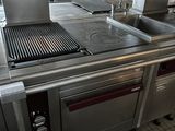 a large kitchen with stainless steel appliances and a stove