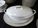 a lot of plates and bowls that are on a table