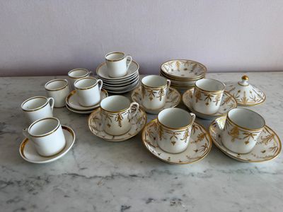 many cups and saucers sitting on a marble table