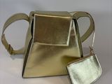silver and gold handbag and wallet on a white surface