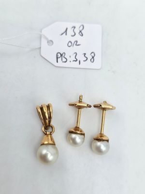 two pairs of pearl and gold earrings with a price tag