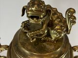 a gold plate with a dog on it on a white surface