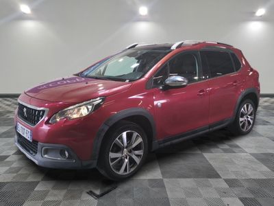 la voiture rouge est garée sur un sol en damier dans le garage