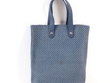a blue tote bag on a white background