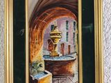 painting of a water fountain in a gold frame on a white wall