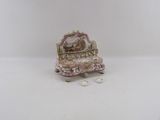 a miniature chair with a mirror on top of it