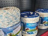 several rolls of rope are on a shelf in a store