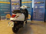 a scooter that is parked in a showroom