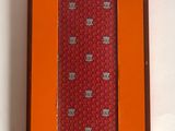 an orange box with a red tie in it on a white surface