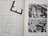 an open book with a picture of a plan and a picture of a building