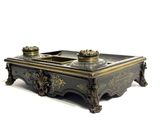 an image of a black and gold table with two candles