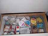 a drawer full of assorted items in a kitchen