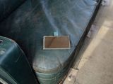 a green couch with a small window in it