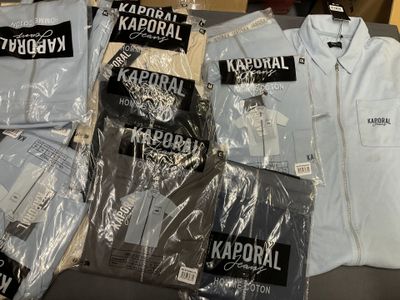 a lot of shirts that are sitting on a table