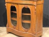 a wooden cabinet with two glass doors on it