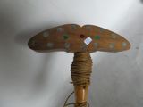 a wooden object that is on top of a rope