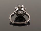 a close up of a silver ring on a black surface