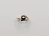 an image of a black pearl ring on a white surface
