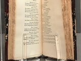 two open books on a table with a pen in it