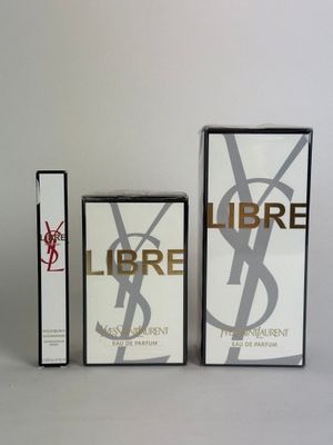 two boxes of perfume sitting next to each other on a white surface